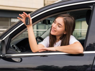 happy-young-smiling-woman-with-new-car-key