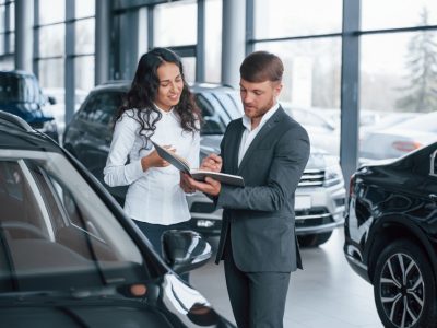 where-i-need-to-sign-female-customer-and-modern-stylish-bearded-businessman-in-the-automobile-saloon